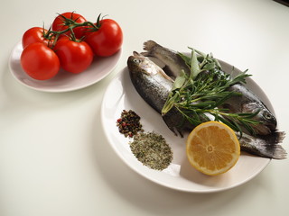 Fresh raw rainbow trout fish with spice and herbs