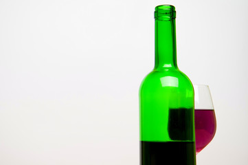 Wine glass and bottle on white