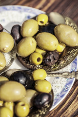 Bowl filled with fresh black olives served as an accompaniment or appetizing snack