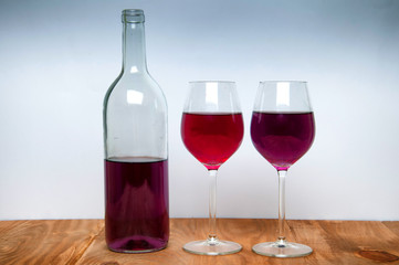 Wine glass and bottle on a wooden table