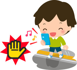 駅のホームでスマホゲームをしながら歩く男の子