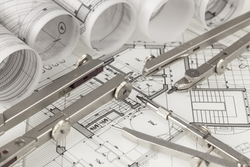 rolls of architecture blueprints, house plans &  compasses