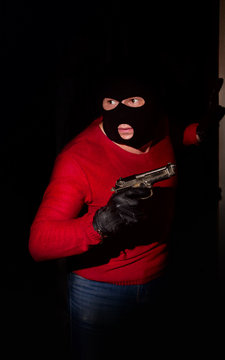 gangster with gun in mask