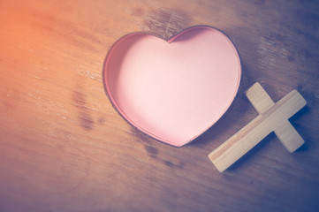 Heart and crosses on wood background