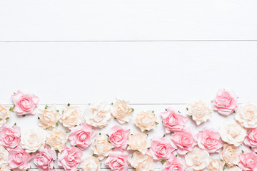 Pink and white roses on white wooden background with empty copys