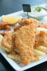  Fish and chips served with cream and vegetables