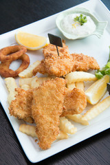  Fish and chips served with cream and vegetables