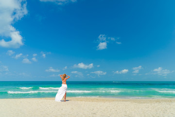 Fototapeta na wymiar Woman walking on the tropical beach