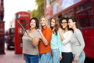 happy women taking selfie by smartphone in london