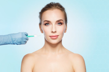 woman face and hand with syringe making injection