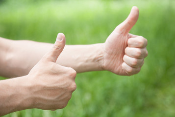 Male hands showing a thumb up sign