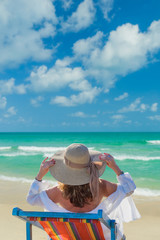 Fototapeta na wymiar Woman in bikini with sunhat at the beach