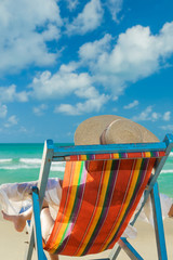 Woman in bikini with sunhat at the beach