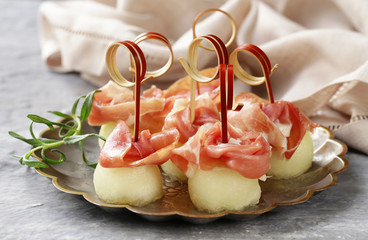 traditional Italian appetizer parma ham with melon - prosciutto melone 