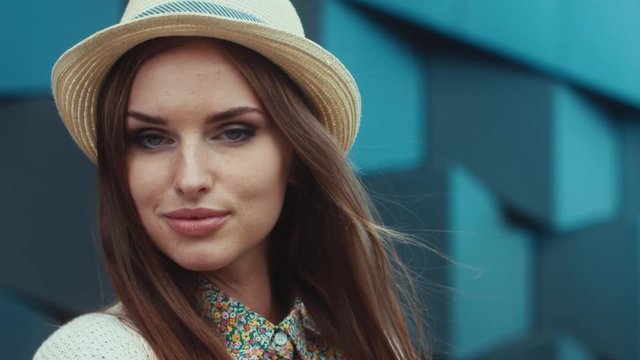 CU RL PAN SLOW MO Portrait of a young beautiful Caucasian female wearing vintage straw hat. 4K UHD 60 FPS