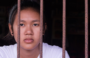 Girl in cage with eye sad and hopeless