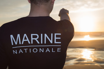 French man of the Marine looking at the sea, sunset.