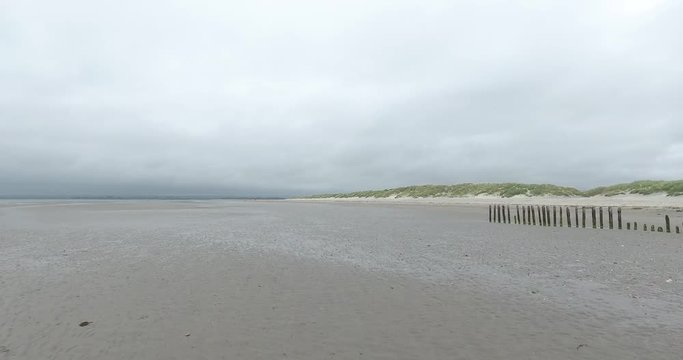 Drone footage of Wittering Beach. Flying up and turning in towards the land.