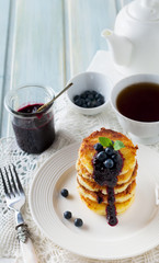 Cottege cheese pancakes Gluten-free with blueberry sauce on a light background. Selective focus.
