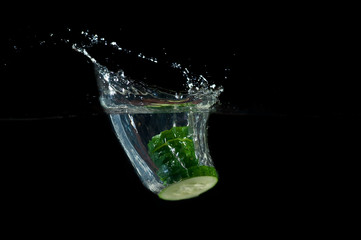 Sliced cucumber splashing water