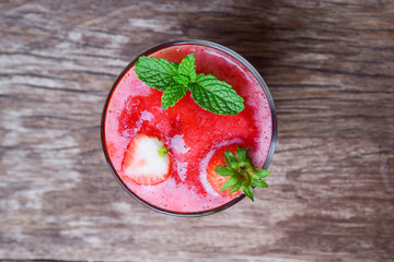Top view of strawberry smoothies on blurred old wood table 