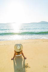 Woman in bikini and hat  at beach
