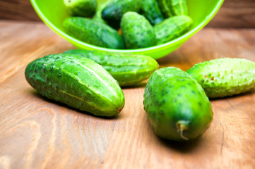 Mini cucumbers in bowl on table
