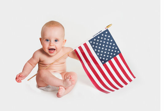 adorable baby girl holding an american flag on white background