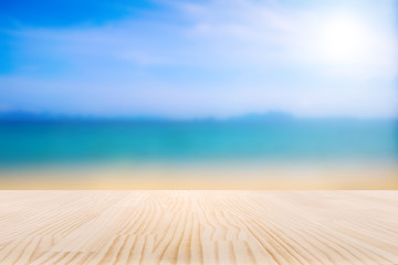 Fototapeta na wymiar Wood table top on blurred beach and tropical background