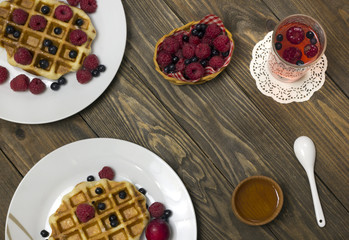 Fototapeta na wymiar Two white plates with waffles honey and spoon