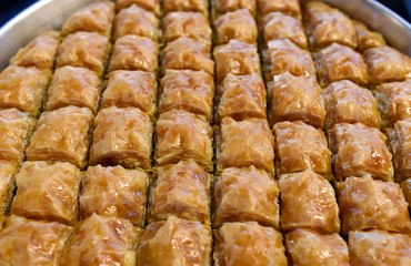 Baklava is a rich, sweet pastry made of layers of filo filled with chopped nuts and sweetened and held together with syrup or honey
