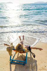 Fototapeta na wymiar Young woman in hat sitting on beach