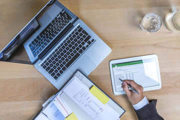 Accounting on a tablet computer and laptop, close-up