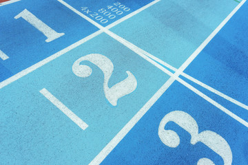 Red treadmill of special materials in the stadium with numbers starting position. Finishing or  section  the running track  numbered lanes.