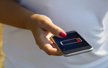 Fototapeta premium white woman using the phone with low battery