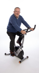 ELDERLY MAN ON AN EXERCISE BIKE  An elderly man trying out an exercise bicycle