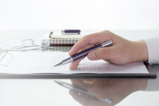 Hand with pen over application form, Businessman signing a contract with ballpoint concept.