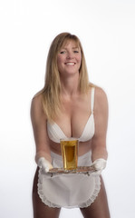 WAITRESS SERVING BEER FROM A TRAY   A scantily dressed waitress holding a silver tray and a glass of beer