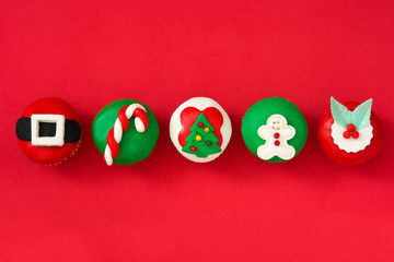 Christmas cupcakes on red background

