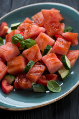 Close-up of salad with grilled watermelon, tomatoes and cucumber