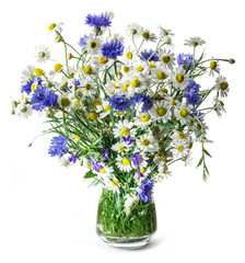 Bouquet of chamomiles and cornflowers in the vase on the white b