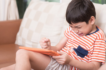 Little boy play game with angry feeling