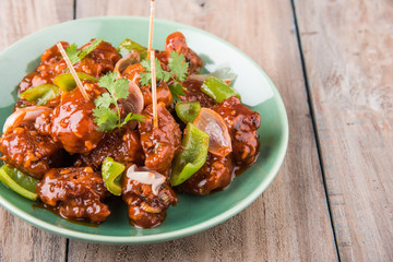indian starter menu - Crispy Veg dipped in red sauce with onion and capsicum, vegetables with corn...