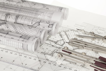 rolls of architecture blueprints, house plans &  compasses