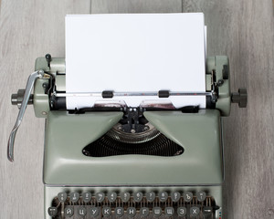 The old used writing machine with the marks of use on the textured backind
