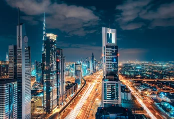 Rolgordijnen Scenic Dubai downtown architecture. Nighttime skyline with illuminated skyscrapers and highway. Fantastic travel background. © Funny Studio