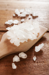White sea salt on wooden spoon