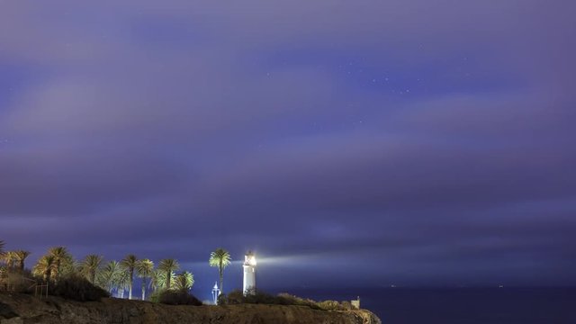 4K Video of beautiful landscape around Vicente Lighthouse at night with clouds and stars, California