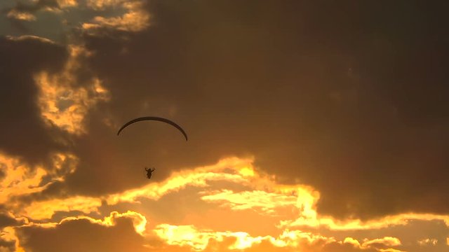 Paramotor Flying at Sunset and Beautiful Clouds