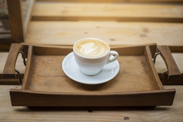 hot latte art on wood table background